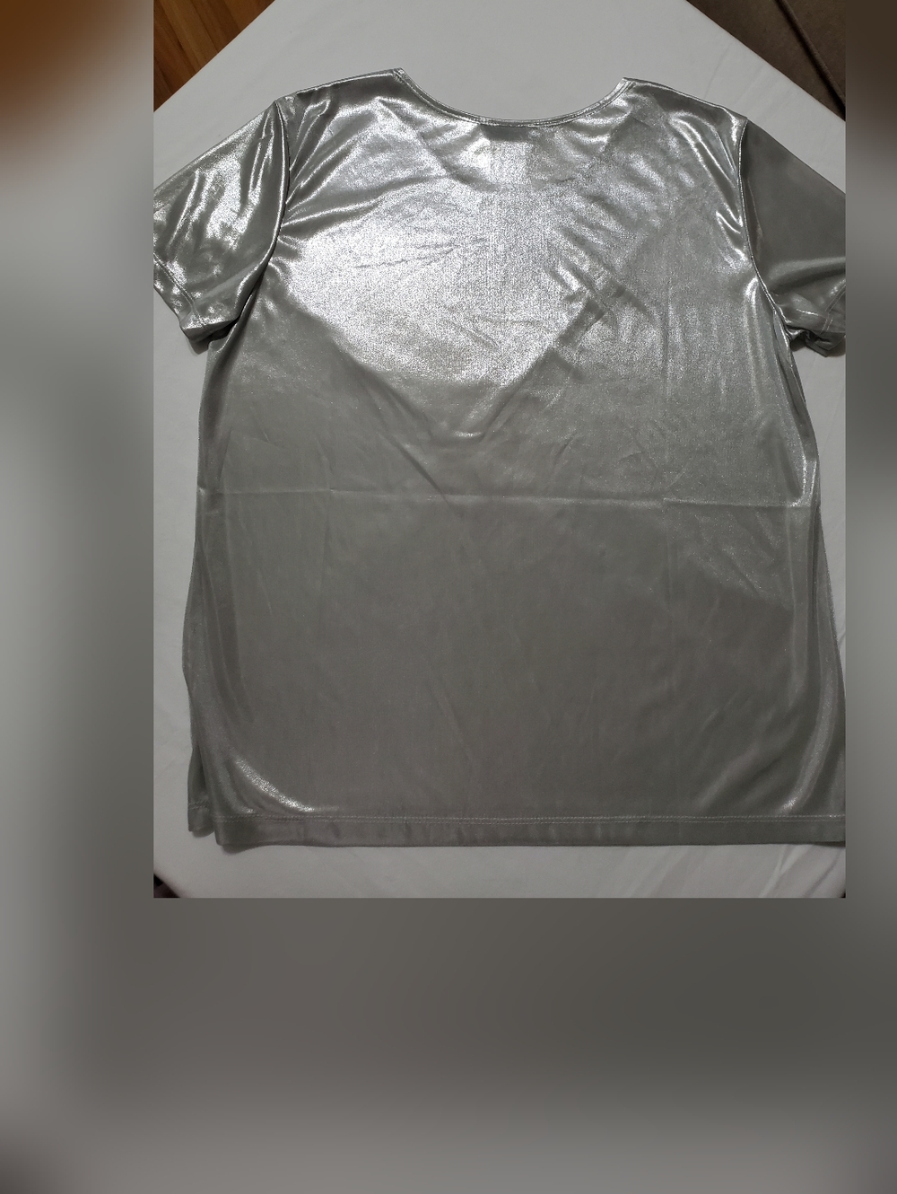 Statement silver metallic top with a sleek, high-shine finish